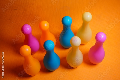 Bright colorful plastic bowling pin toys for children, promoting indoor fun, coordination skills, and playful learning activities.