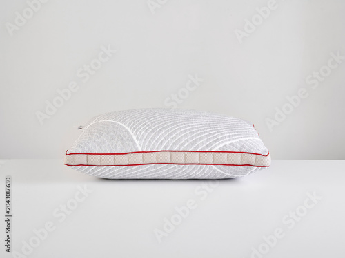 Single white pillow isolated on white background, minimal clean composition emphasizing softness, comfort, hygiene, and modern bedding product presentation with simple, elegant aesthetic style.