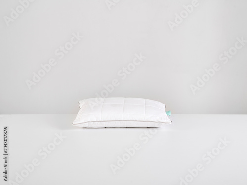 Single white pillow isolated on white background, minimal clean composition emphasizing softness, comfort, hygiene, and modern bedding product presentation with simple, elegant aesthetic style.
