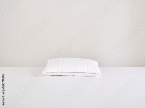 Single white pillow isolated on white background, minimal clean composition emphasizing softness, comfort, hygiene, and modern bedding product presentation with simple, elegant aesthetic style.