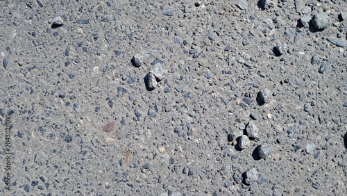 Light Gray Gravel Road Surface Texture with Sparse Stones Background