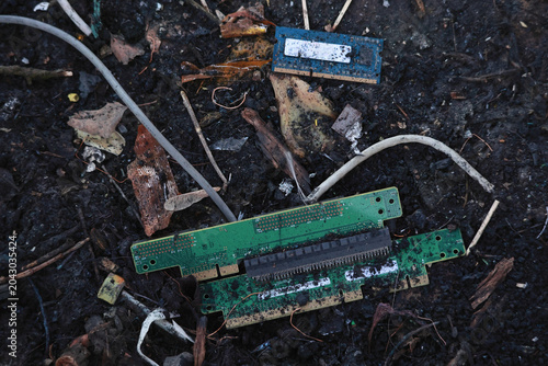 Slika na platnu Electronic waste and discarded circuit boards on the ground