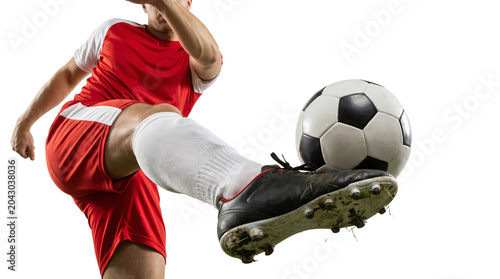 soccer player in uniform kicking ball