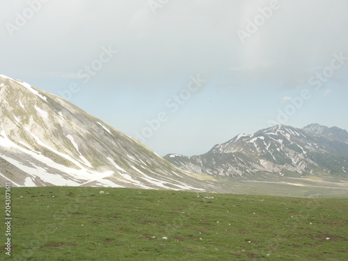 Panoramic view of the Gran Sasso mountains with late spring snow patches in Campo Imperatore, Abruzzo, Italy