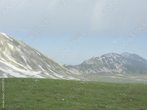 Panoramic view of the Gran Sasso mountains with late spring snow patches in Campo Imperatore, Abruzzo, Italy