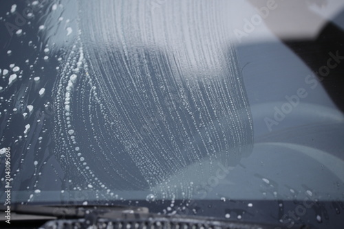 Tableau sur toile Car windshield receiving soap suds at automatic car wash