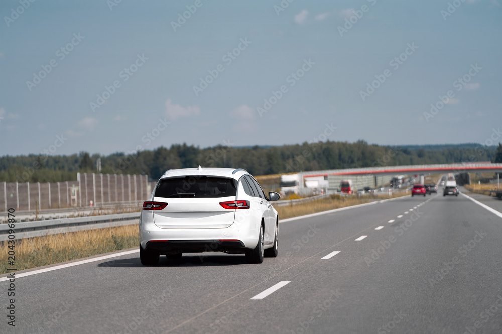 Fototapeta premium Estate car traveling on a clear highway road