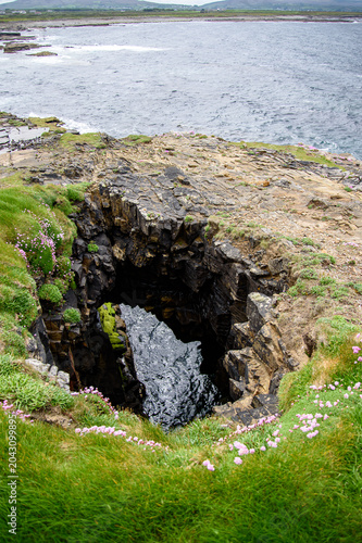 Photography Scenic high angle view of a natural coastal blowhole and collapsed sea cave on a