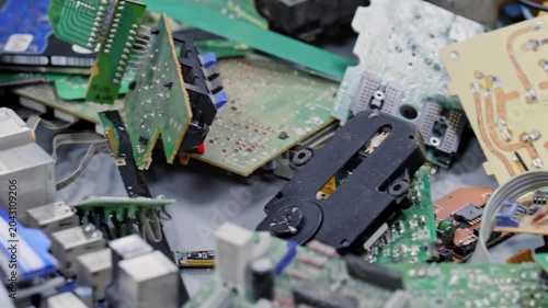 4K Video of pile of disassembled electronic waste with circuit boards, microchips, computer components, and plastic casings, showcasing e-waste recycling, technology disposal, hardware salvage