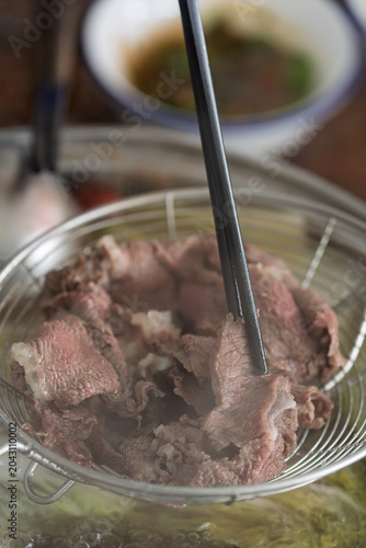 Obraz na płótnie Chaoshan beef hot pot colander holding freshly blanched fresh beef