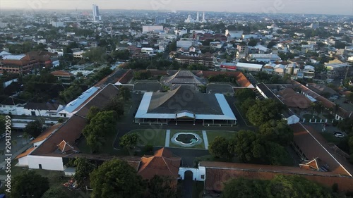 Aerial 4k view of the historic Yogyakarta Kraton palace complex and the surrounding city skyline.