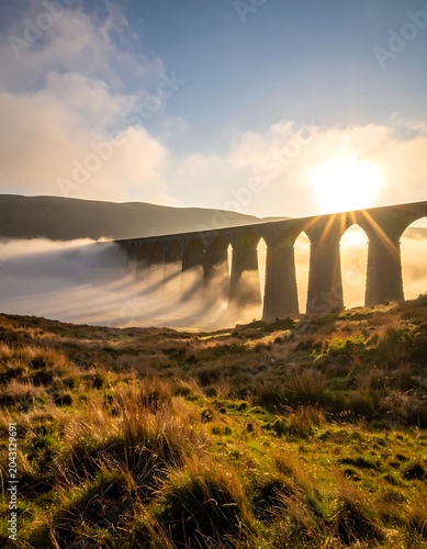 A serene landscape with a bridge above foggy hills