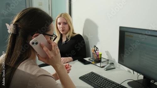Doctor talks by mobile phone as woman patient waits for consultation in clinic slow motion. Physician appointment in healthcare facility