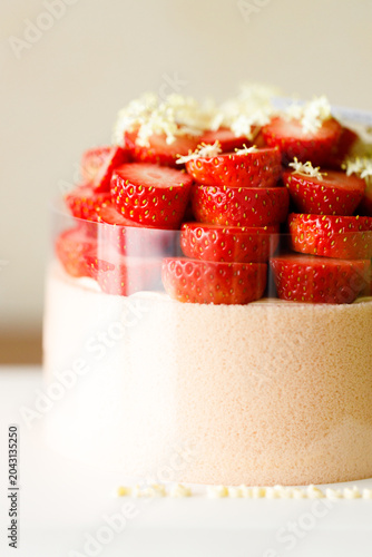 Cake topped with fresh strawberries.