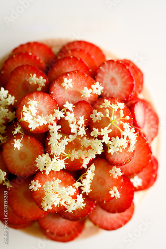 Cake topped with fresh strawberries.
