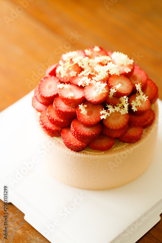 Cake topped with fresh strawberries.