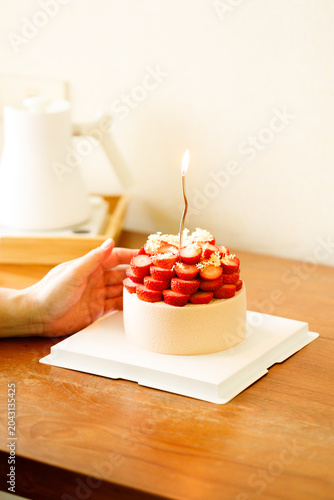 Cake topped with fresh strawberries.