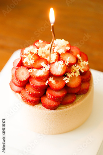 Cake topped with fresh strawberries.