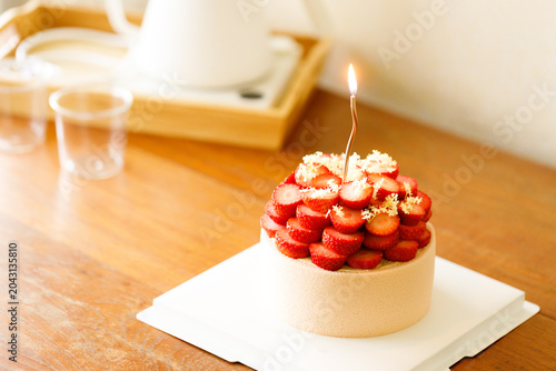 Cake topped with fresh strawberries.