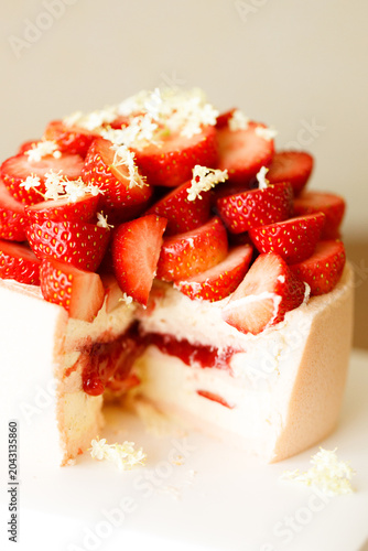 Cake topped with fresh strawberries.