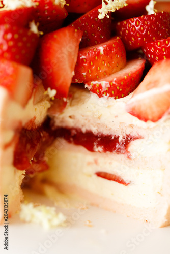 Cake topped with fresh strawberries.