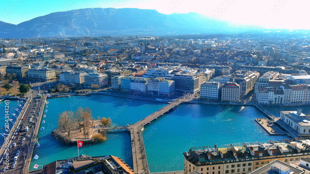 Obraz premium 4K aerial drone view of Geneva, Switzerland. Panoramic cityscape featuring Lake Geneva, Rhone River, Rousseau Island, and Pont du Mont-Blanc.