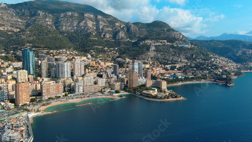 4K aerial drone view of Monaco. Beautiful luxury coastline panorama featuring Larvotto beach, Tour Odeon skyscraper, and the Mediterranean Sea.