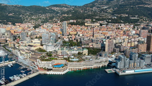 4K aerial drone view of Monte Carlo, Monaco. Luxury seaside cityscape featuring the iconic Monte Carlo Casino, Port Hercule, and Mediterranean.