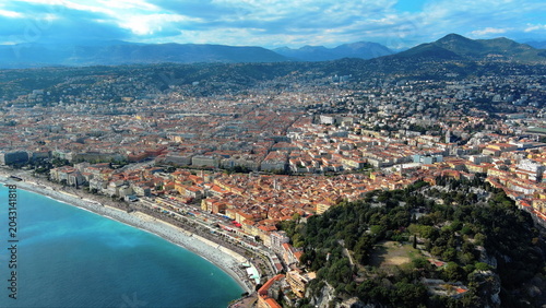 4K aerial drone view of Nice, France. Panoramic summer cityscape featuring the Promenade des Anglais, old town, beach, and Mediterranean Sea.