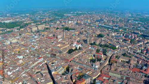 4K aerial drone image of Parma, Italy. Panoramic summer cityscape featuring the historic Duomo, Baptistery, and Palazzo della Pilotta.