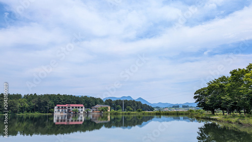 Obraz na plátne Mirror-like reflection of buildings and mountains on Tokura Lake, Yamagata / 山形・