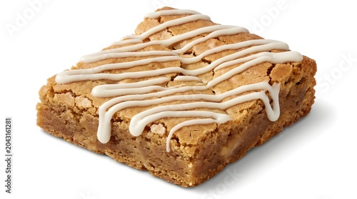 A golden brown baked blondie with white icing drizzle, isolated on a black background