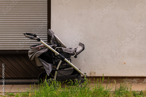 Stroller resting against a wall, hinting at a peaceful day filled with family outings and outdoor adventures