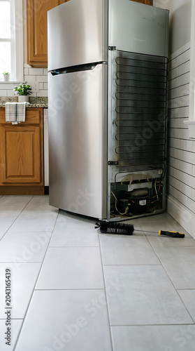 Refrigerator pulled from wall isolated on a clean white background