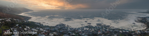 Fotografia Aerial panorama shows storm surf on rocky coves and seaside homes near Camps Bay and Clifton, Cape Town