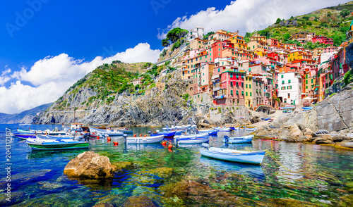 Vibrant colorful houses and boats in Riomaggiore village, Cinque Terre - Italy.