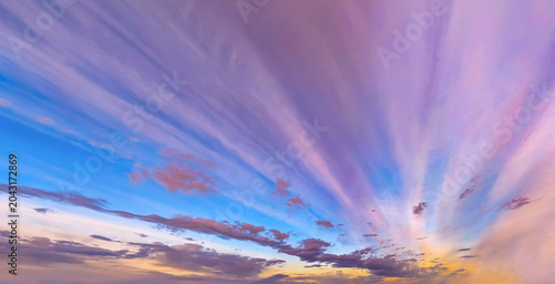 Violet sunset sky cloud backgrounds in the morning with red, orange, yellow color sunrise golden hour vibrant sky, Dramatic dusk storm gold clouds summer sky landscape background