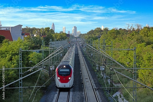High Speed Train on Riedbahn with Frankfurt Skyline