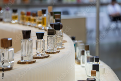 various perfume bottles displayed on exhibition booths at trade show