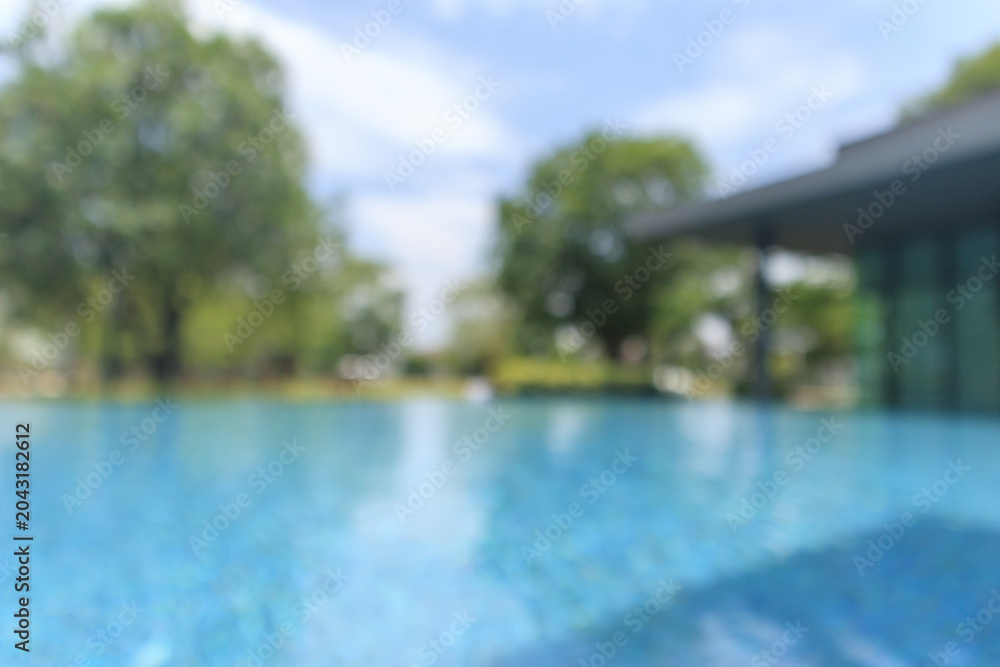 Fototapeta premium Abstract blur outdoor swimming pool in tropical resort hotel summer background