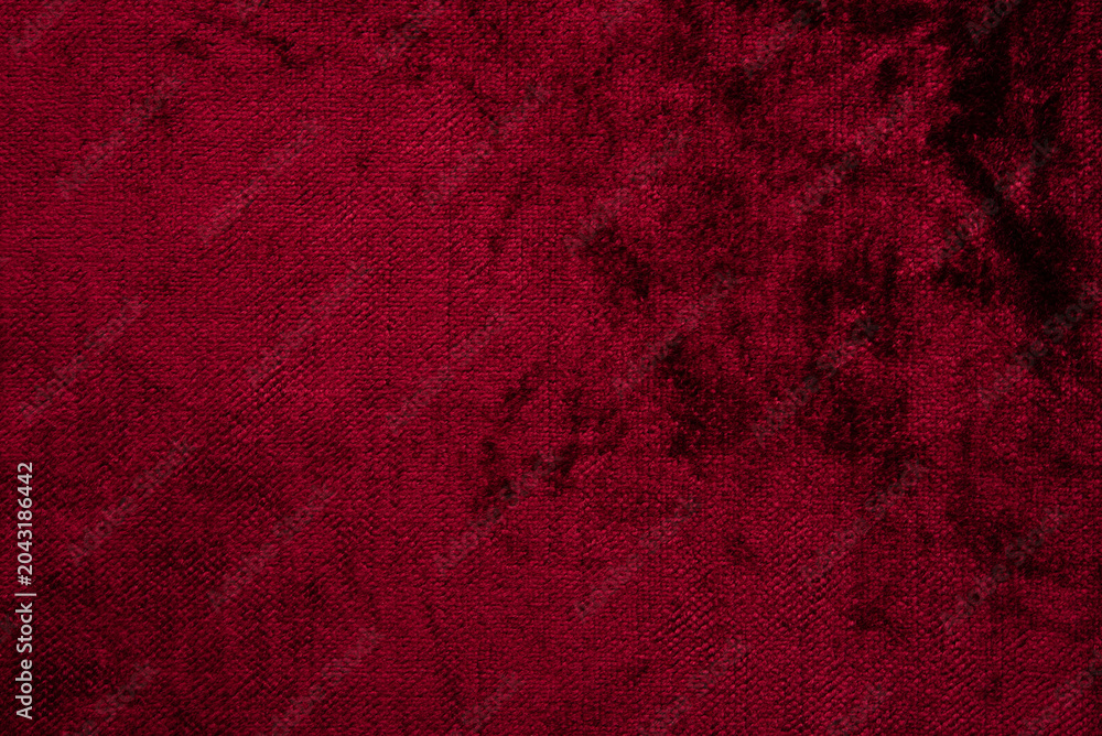Obraz premium Dark red purple crushed velvet texture background, luxury burgundy velour fabric with soft shiny pattern.