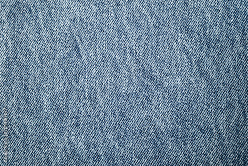 Obraz na plátně Blue denim fabric texture with uneven coloration and a visible weave pattern