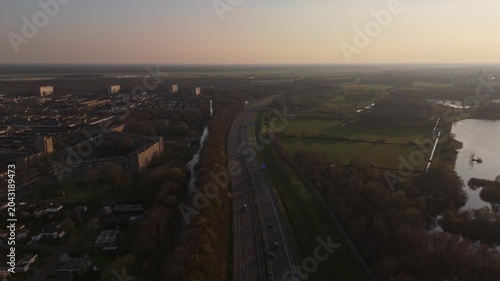 Aerial flyover above highway traffic near Vlijmen at Golden Hour