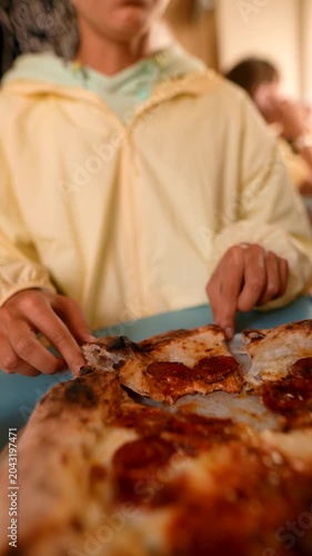 Pizza bite satisfaction. Eating spicy pizza with delight