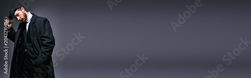Fotografie Handsome red haired man showcasing stylish fashion in a modern setting