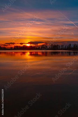 Summer sunset or sundowner view with reflections near Plattling, Isar, Deggendorf, Bavaria, Germany