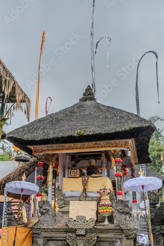 Indonesian statue in a temple with offerings