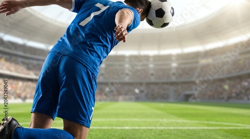 Dynamic composition capturing a male soccer player's powerful header mid-game within a vast, sun-drenched stadium, highlighting athletic precision and competitive intensity