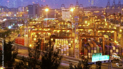 Cargo terminal port timelapse in Hong Kong of China. Busy cargo container loading activities. Rush hour road and traffic. Beautiful vibrant city vibe.