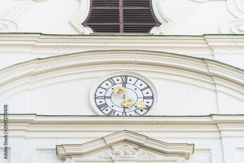 Baroque style white church tower with tower clock